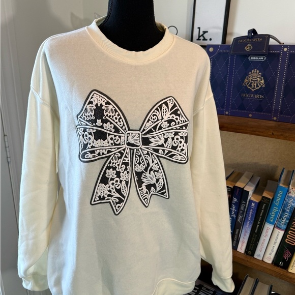 refuge Sweaters - Cream Sweater with Black Bow Design